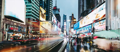 A bustling cityscape with illuminated billboards, skyscrapers, and busy traffic at dusk.