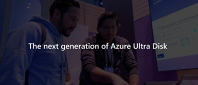 一群人站在显示“下一代 Azure 超级磁盘”字样的电脑屏幕旁。