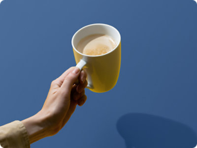 A hand holding a cup of coffee.