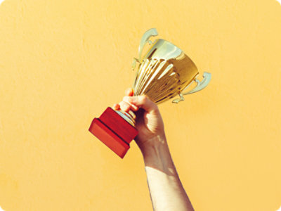 A hand holding a trophy.